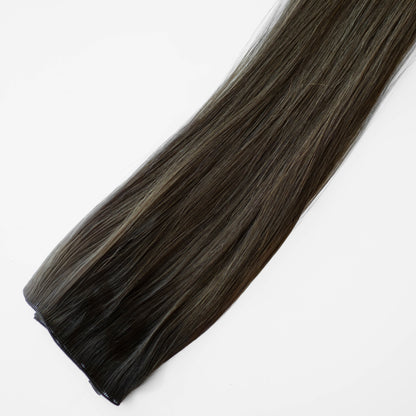 Dark brown hair extension on a white background