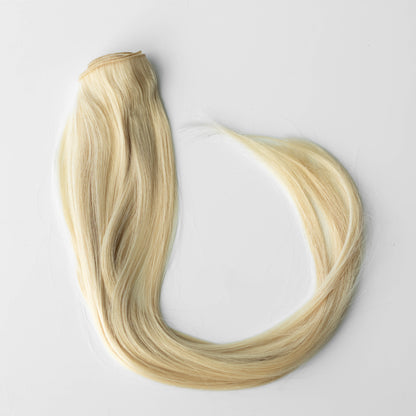 Blonde hair extensions on a white background